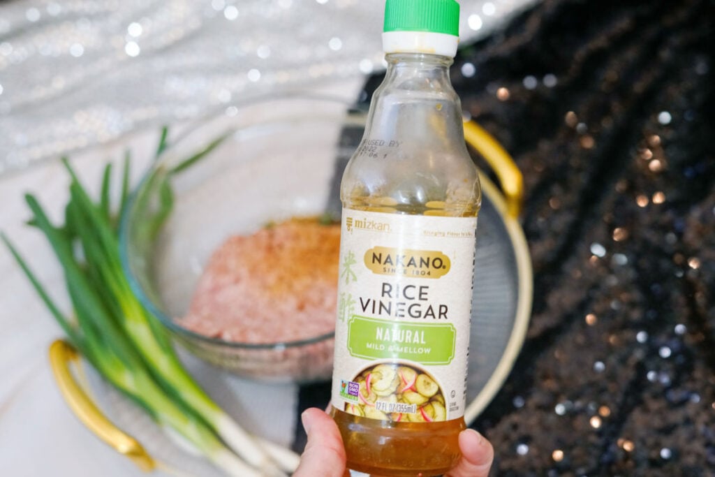 adding rice vinegar to ground pork
