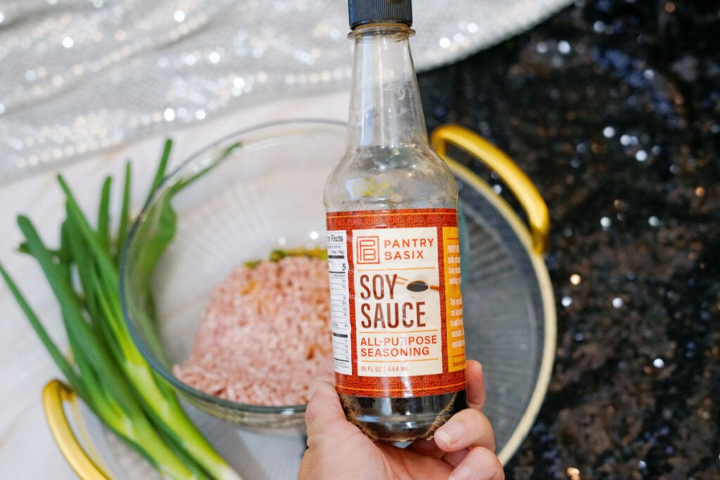 adding soy sauce to pork