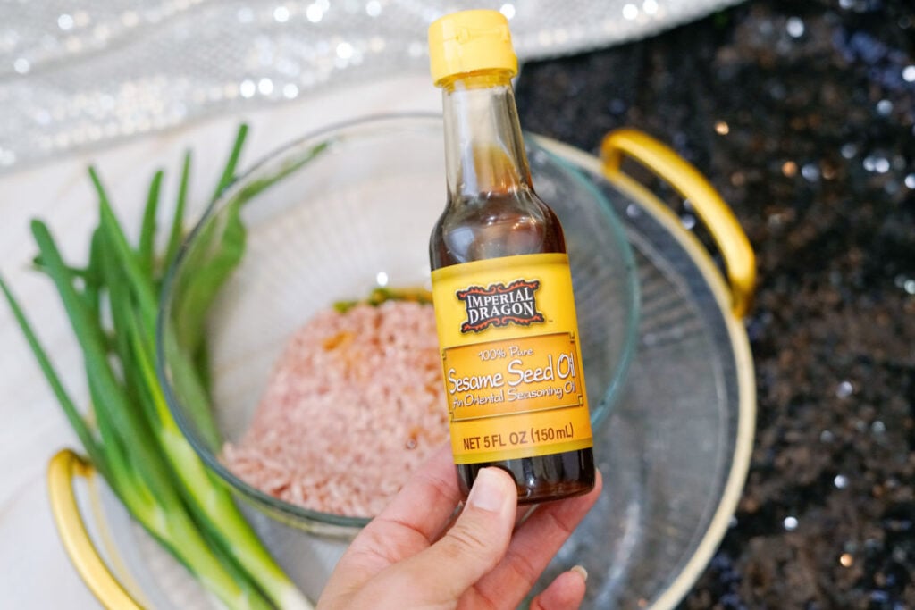 adding sesame oil to ground pork