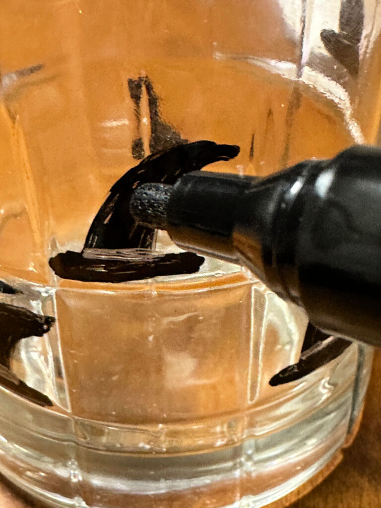 painting a witch hat on a tumbler
